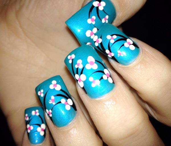dotted flowers on turquoise spring nails