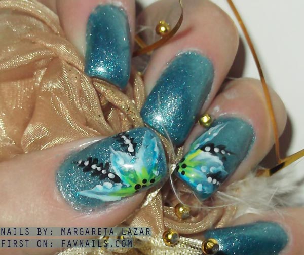 freehand flowers on blue shimmer nails