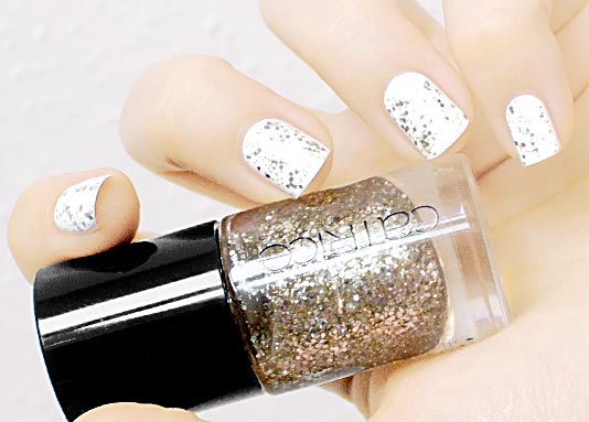 gold glitter on white festive nails