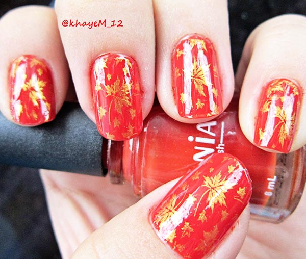 gold leaves stamped on orange fall nails