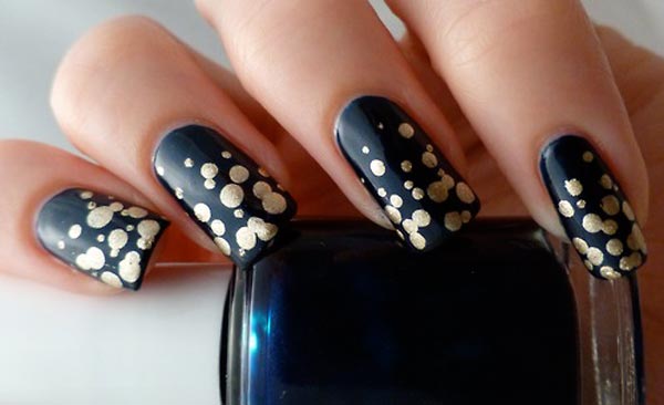 gold shimmer dots on black nails