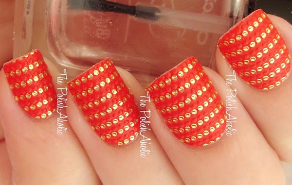 golden applique rows on orange nails