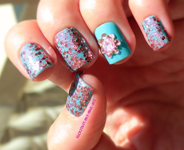 pink glitter flower on turquoise nails