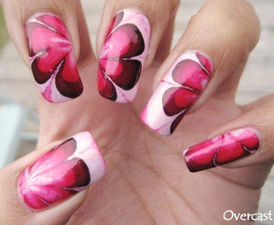 red marbled flowers on pink nails
