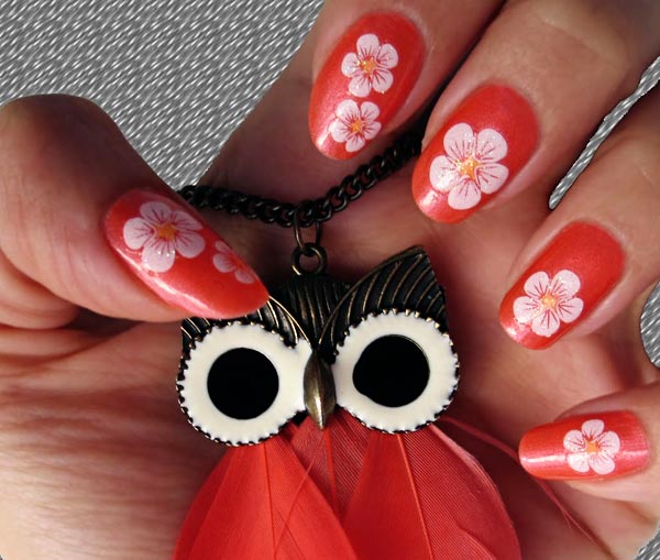 white flowers on coral nails